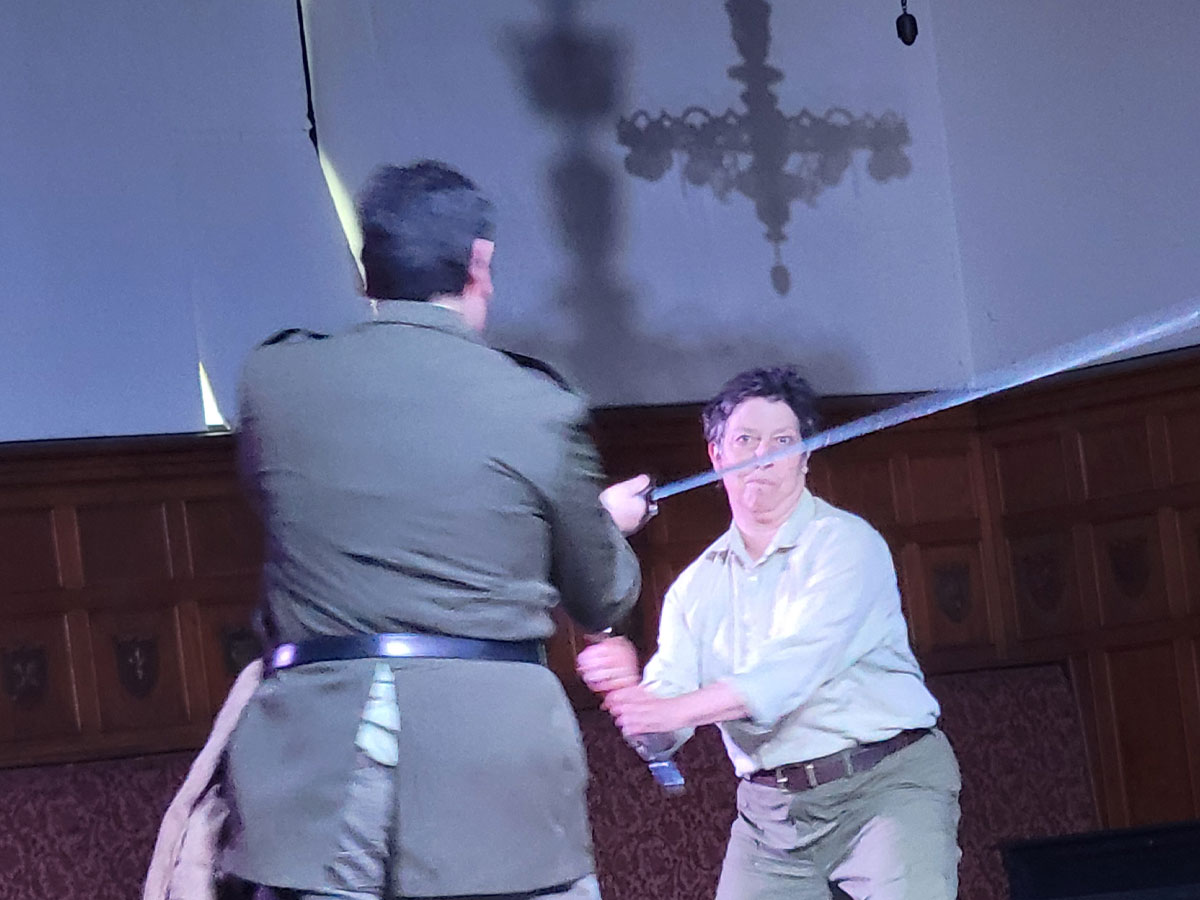 Macduff (AJ Sage) and Macbeth (Barbara Geary) fight to the death.